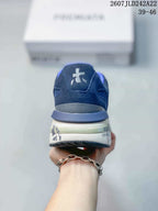 Rear view of the navy blue trainers showing the padded heel, white logo detail and printed midsole graphics.