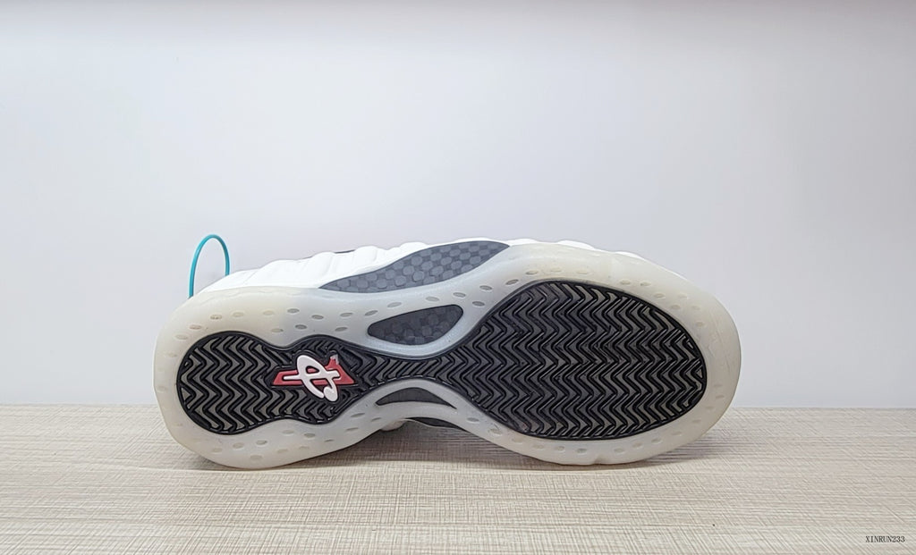 Underside view showing the patterned outsole of the Nike Air Foamposite One sneakers.