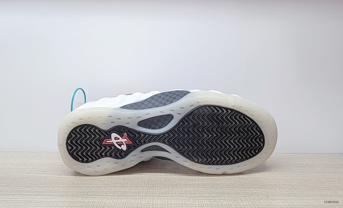 Underside view showing the patterned outsole of the Nike Air Foamposite One sneakers.