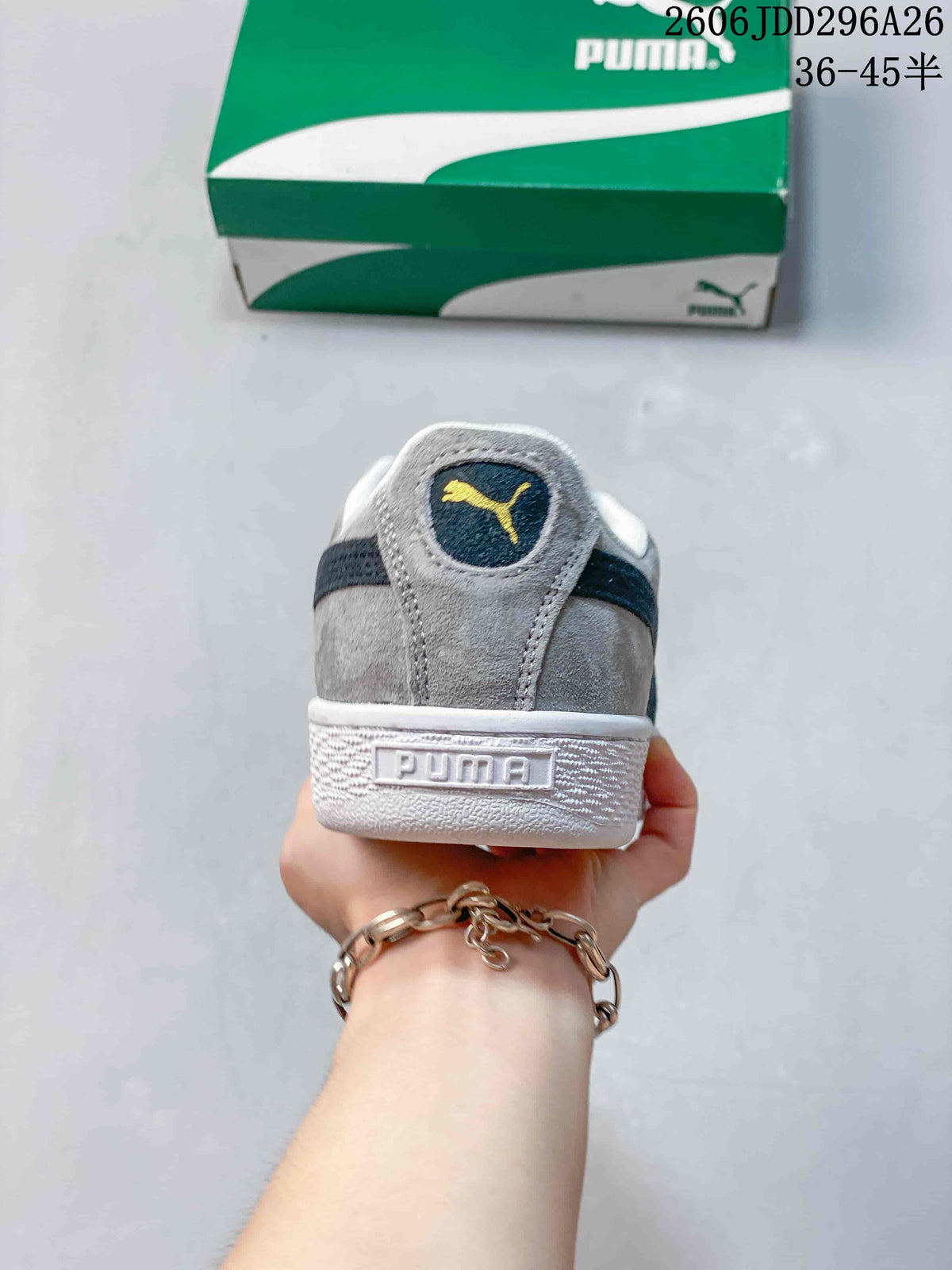 Rear view of a gray Puma sneaker showing the heel logo, dark navy heel detail and white textured sole.