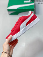 Side view of the red sneaker showing the white PUMA formstrip and textured white outsole.