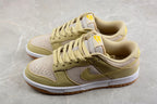 Pair of sesame and beige low-top sneakers shown from a three-quarter angle