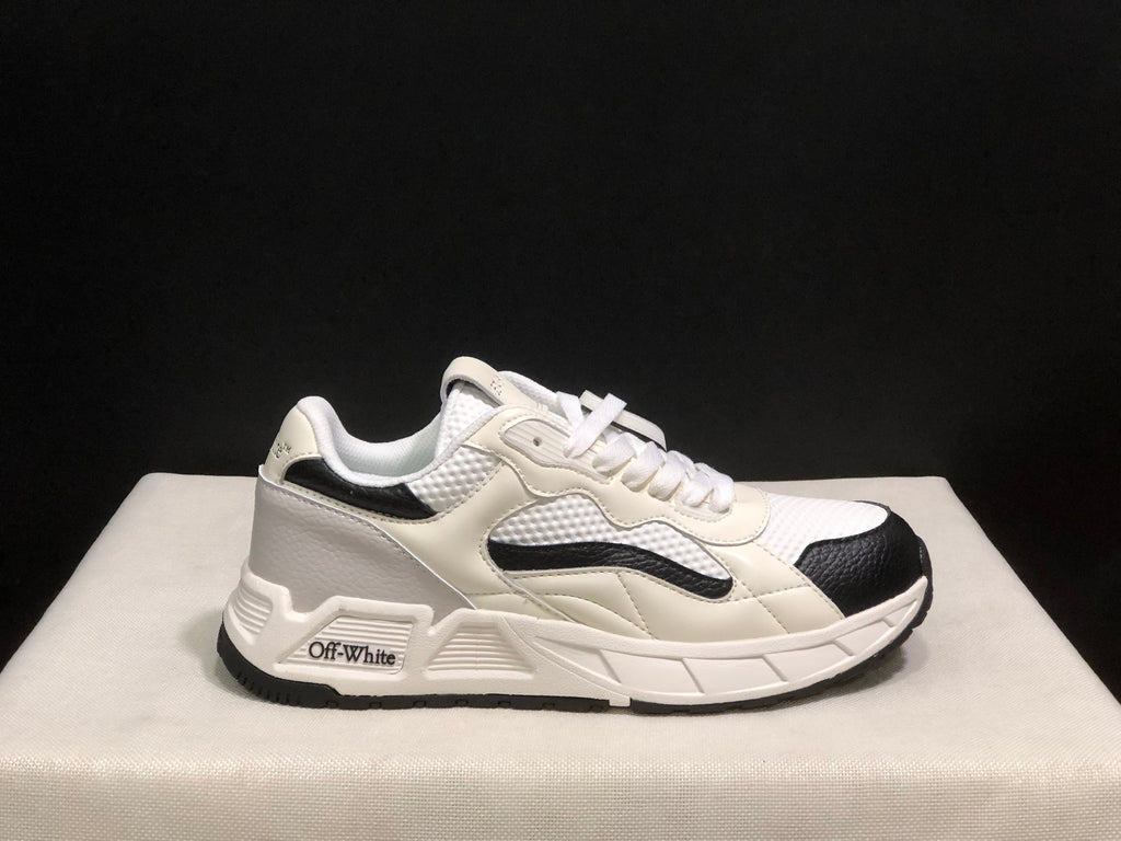 Single side profile of the sneaker showing the white upper, black toe and side accents, and branded side detail.