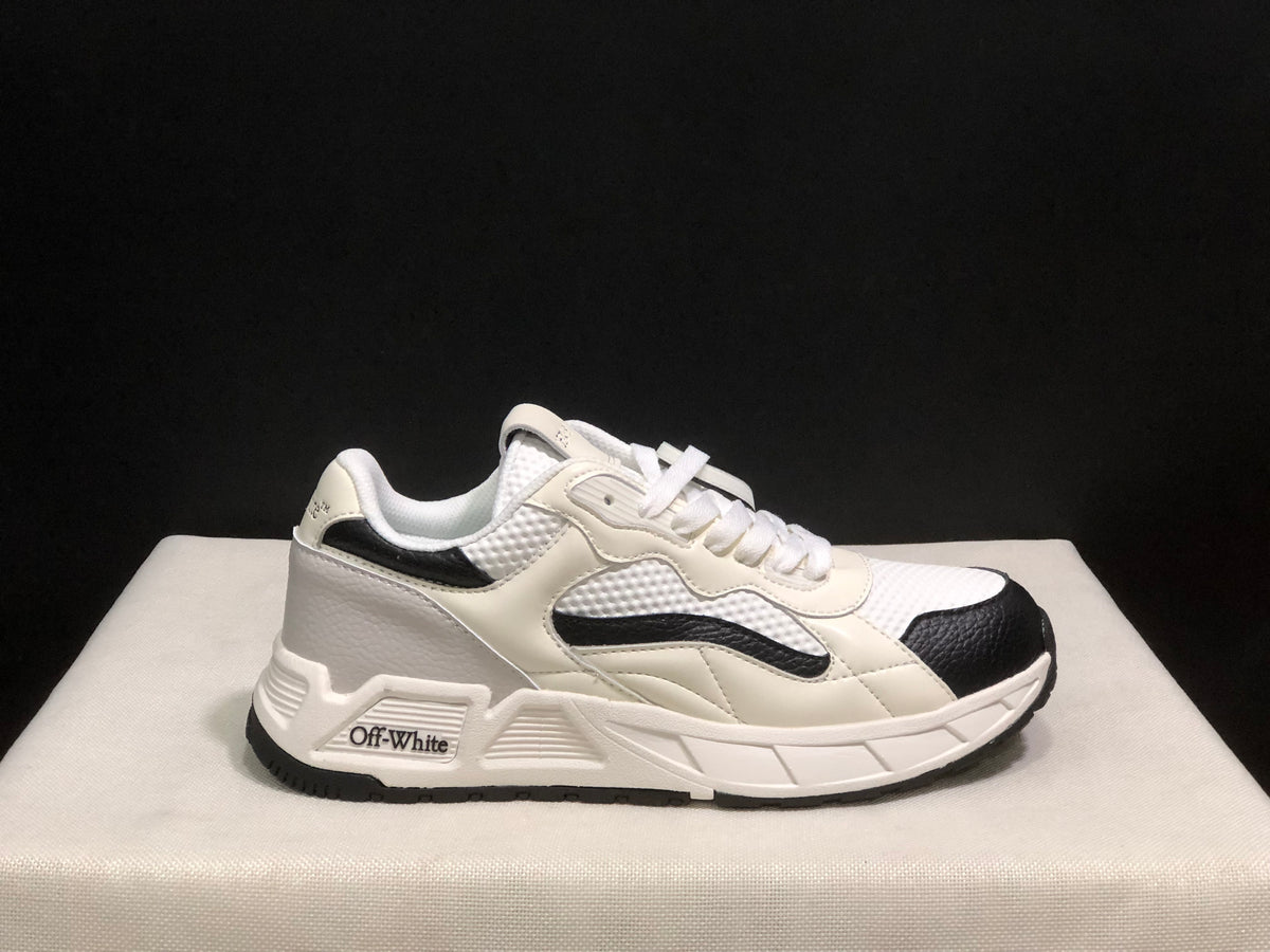 Single side profile of the sneaker showing the white upper, black toe and side accents, and branded side detail.