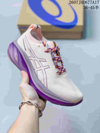 White ASICS Gel-Nimbus 26 sneaker with purple midsole accents and multicolor purple-and-orange laces.