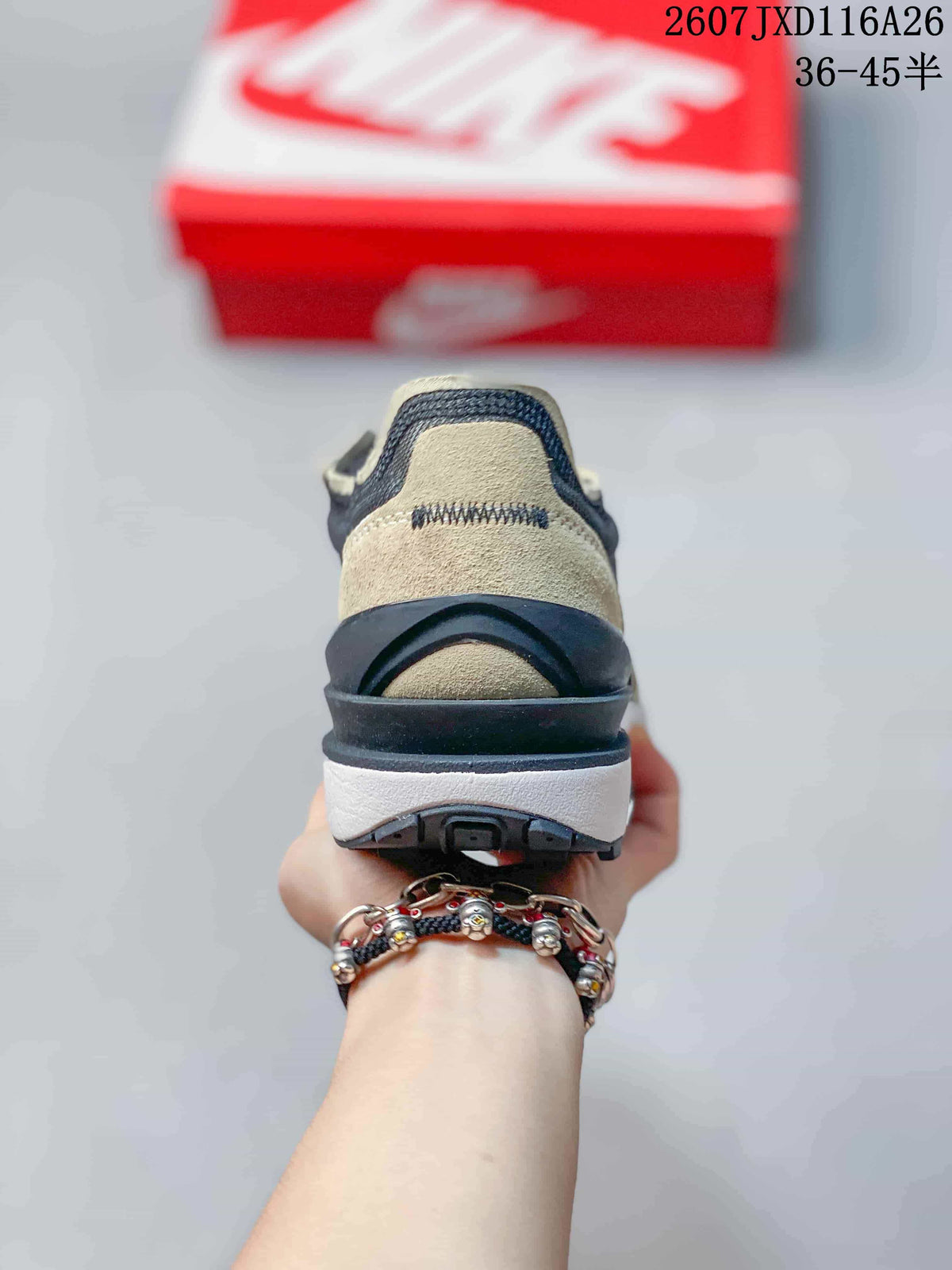 Rear view showing the layered black heel structure, brown heel panel, white midsole, and black outsole.