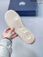 Underside view of the sneaker showing the circular rubber outsole pattern and textured tread.