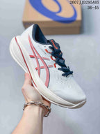White ASICS running shoe with red accents, dark laces, and a white outsole.