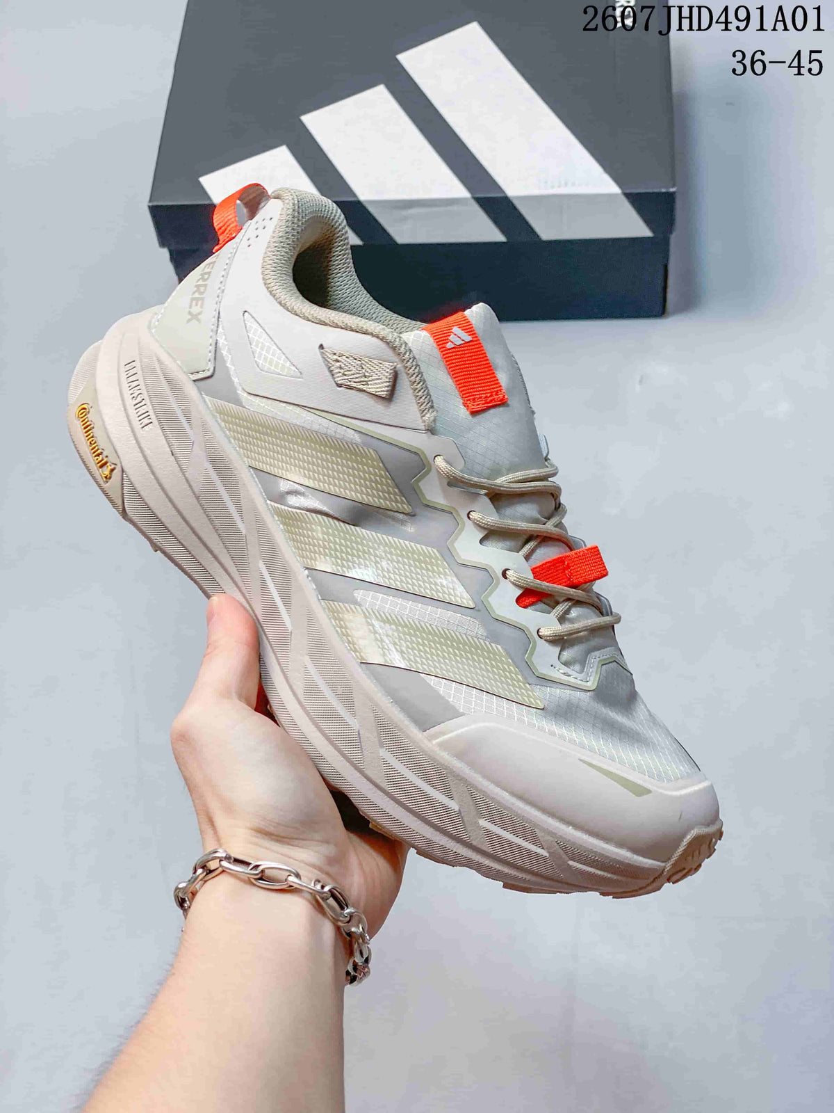 Light gray Adidas Terrex low-top shoe with bright orange accents; image also displays the size range 36–45.