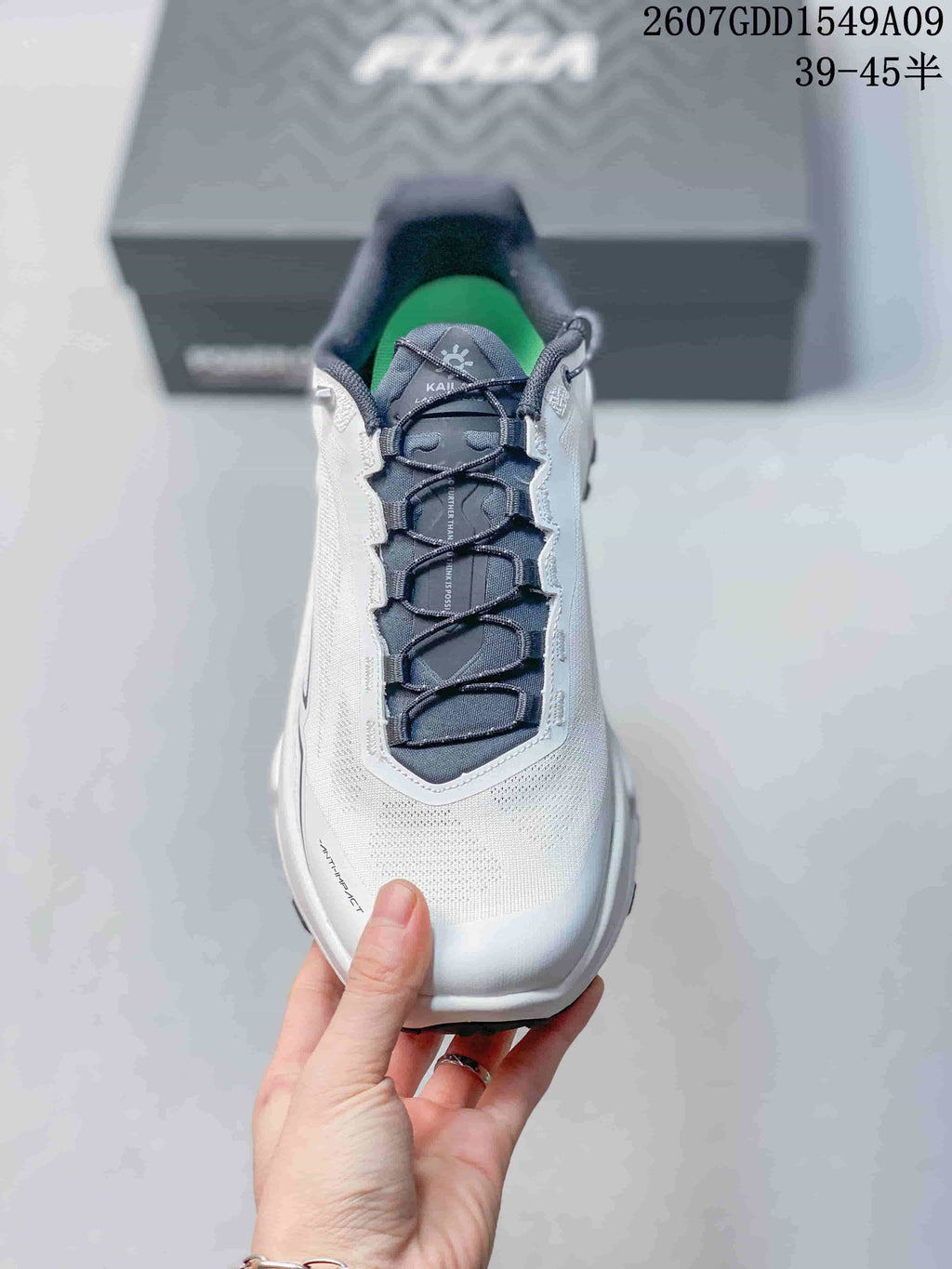 Top view of the shoe showing the white upper, navy tongue and laces, padded collar and green footbed.