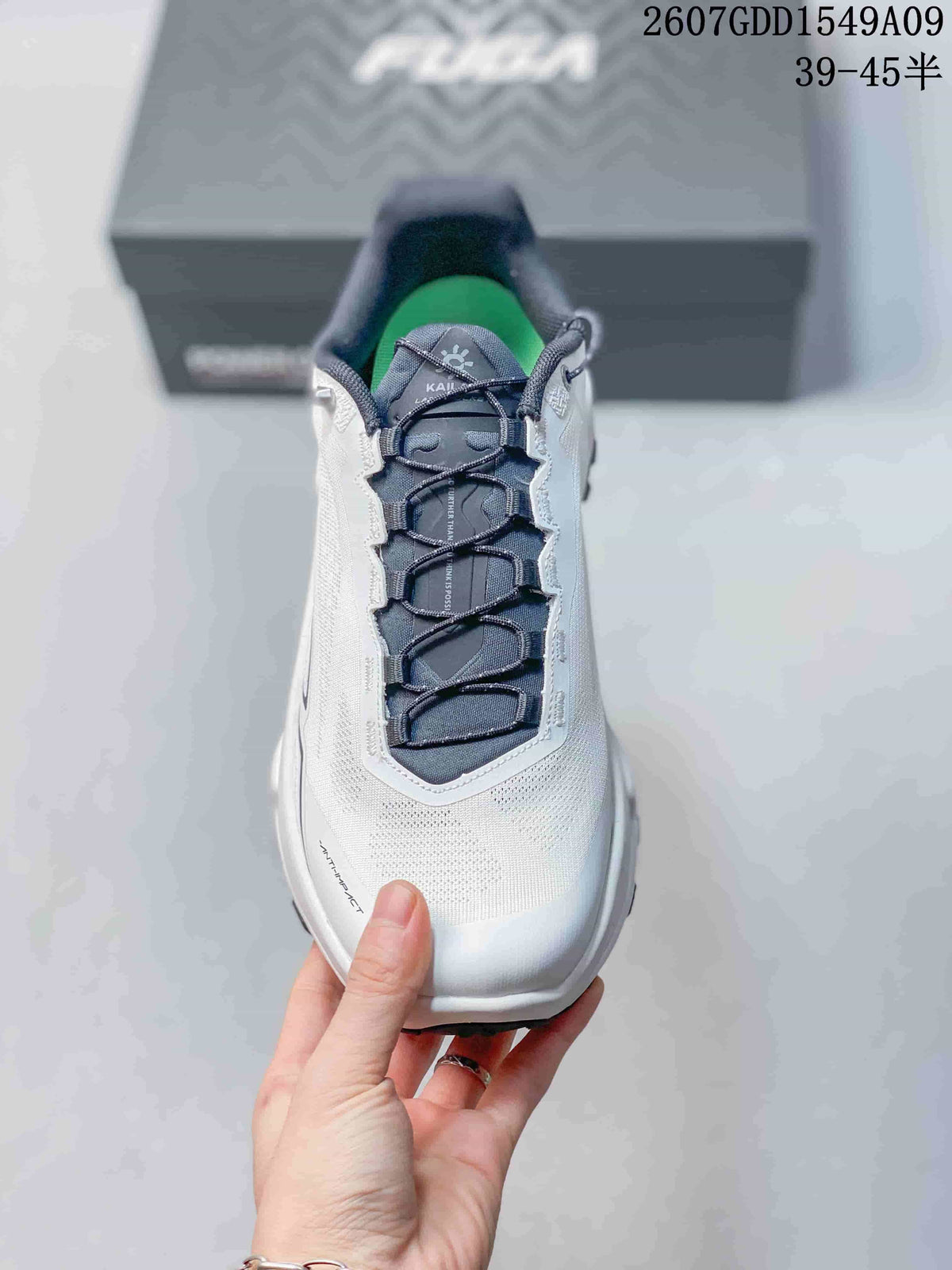 Top view of the shoe showing the white upper, navy tongue and laces, padded collar and green footbed.