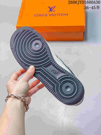 Close-up of the sneaker outsole with circular tread and an orange branded box in the background