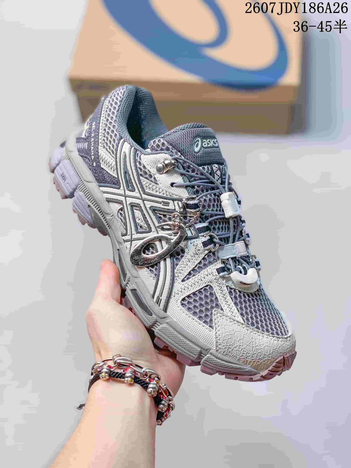 Side view of a gray and white ASICS Gel-Kahana 8 FL sneaker showing layered overlays, mesh panels, lace hardware, and lugged outsole.