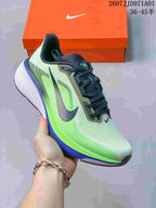 Angled side view of a Nike Pegasus 42 running shoe in light grey, neon green, dark grey, and blue