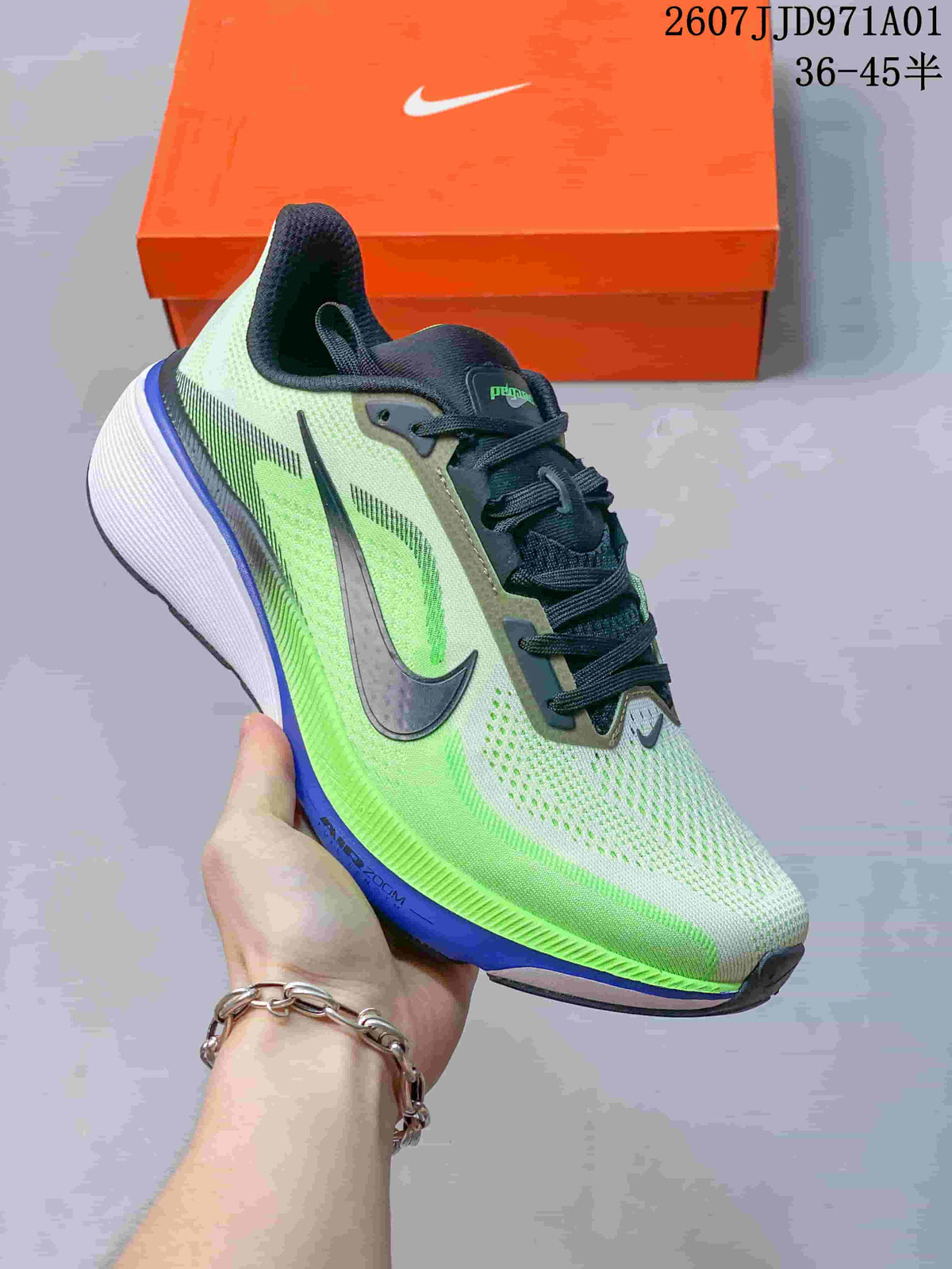 Angled side view of a Nike Pegasus 42 running shoe in light grey, neon green, dark grey, and blue