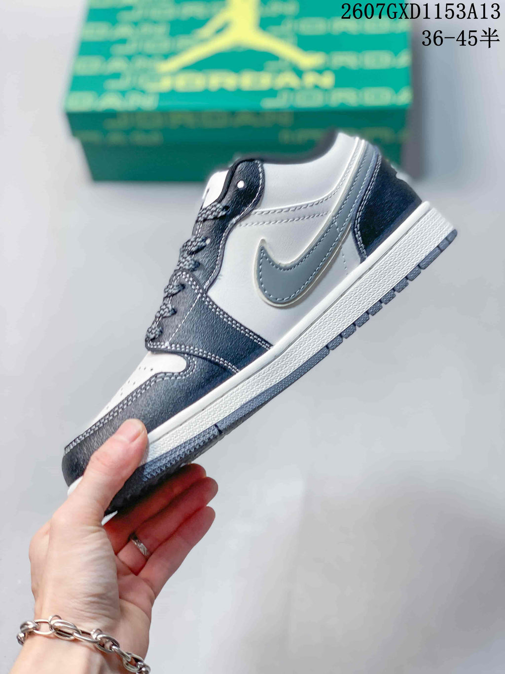 Side profile showing the grey Swoosh, contrasting panels, white midsole and dark outsole.
