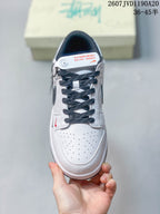 Top view of the sneaker showing the perforated white toe box, dark laces, padded tongue, and contrast detailing.