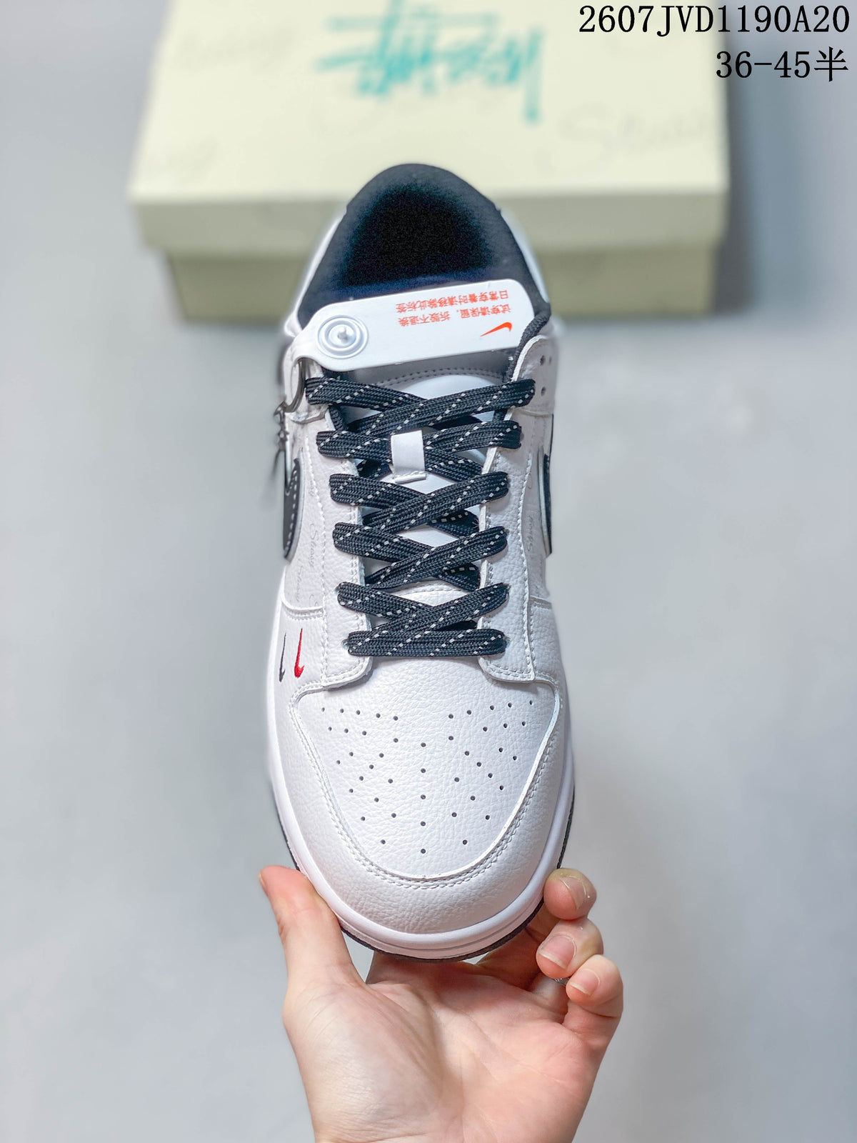 Top view of the sneaker showing the perforated white toe box, dark laces, padded tongue, and contrast detailing.