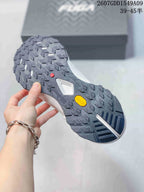 Close view of the shoe outsole showing a deep lug pattern, geometric tread and visible Vibram branding.