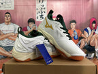 Angled view of the white Mizuno Wave Momentum 3 shoes with dark green accents and gum-colored outsoles