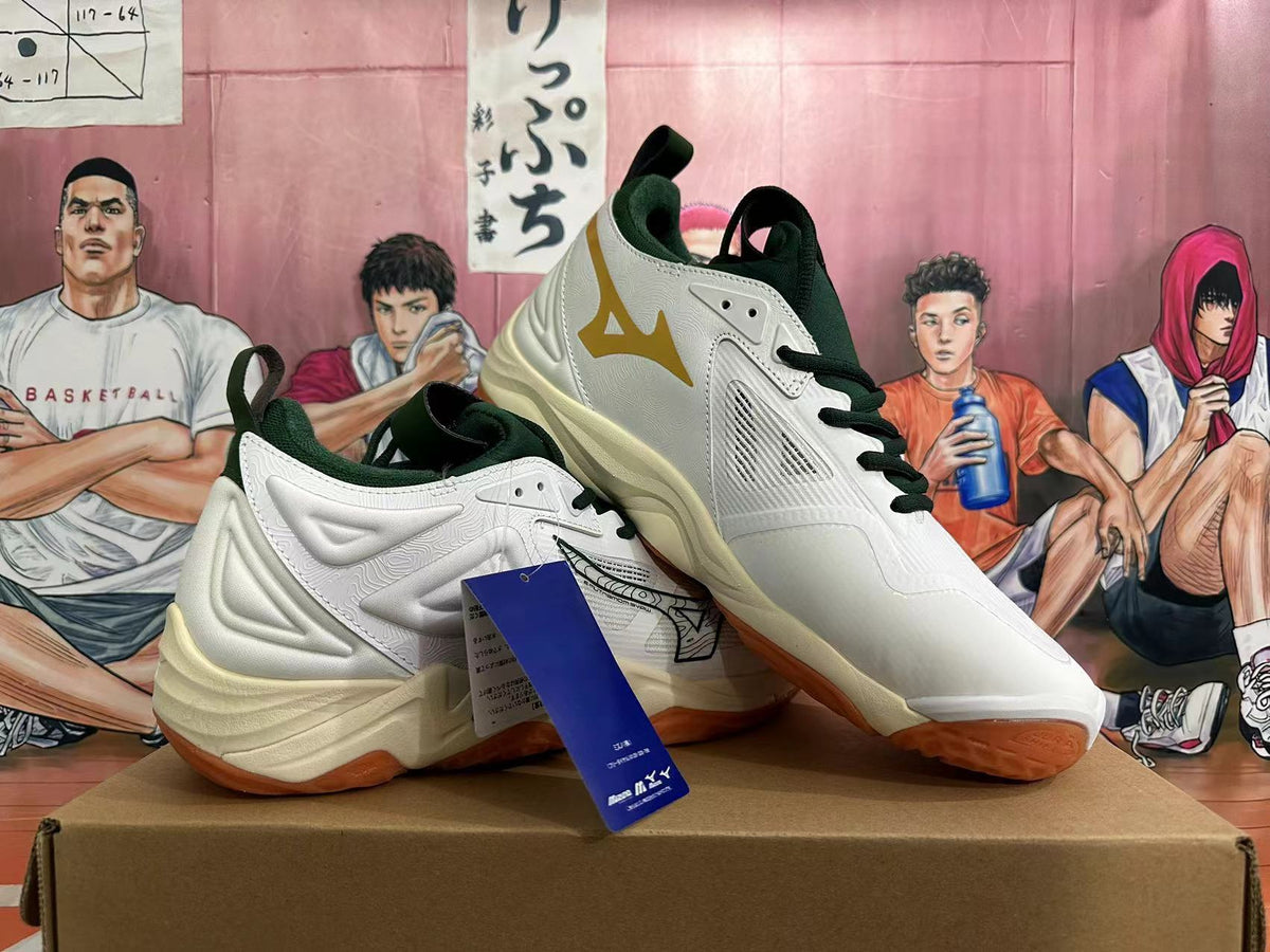 Angled view of the white Mizuno Wave Momentum 3 shoes with dark green accents and gum-colored outsoles