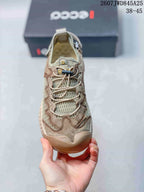Top view showing the mesh tongue, lace system, layered toe panels, and beige-green colorway.