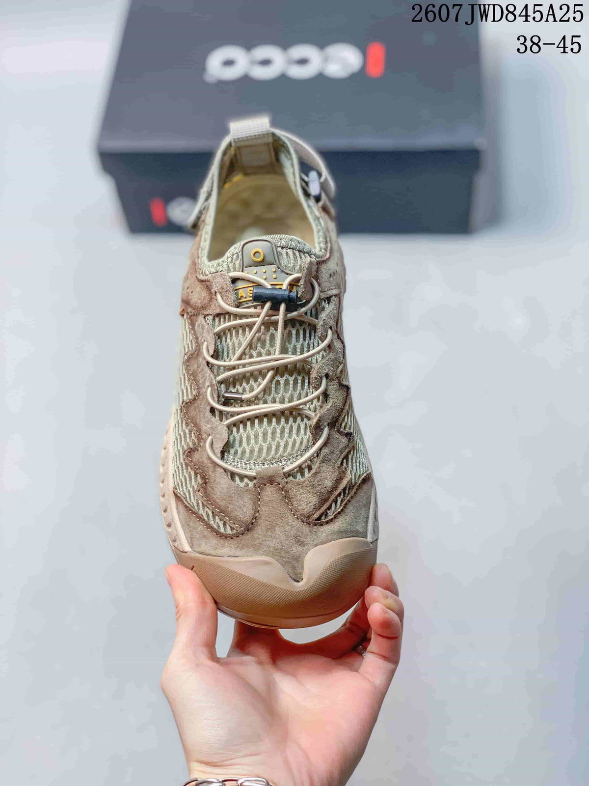 Top view showing the mesh tongue, lace system, layered toe panels, and beige-green colorway.
