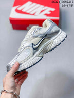 Side profile highlighting the mesh panels, layered overlays, Nike branding and segmented outsole.