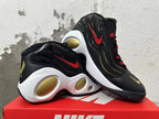 Pair of black Nike Flight sneakers showing red side Swooshes, gold accents, and sculpted white midsoles.