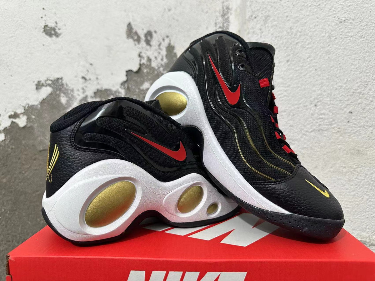 Pair of black Nike Flight sneakers showing red side Swooshes, gold accents, and sculpted white midsoles.