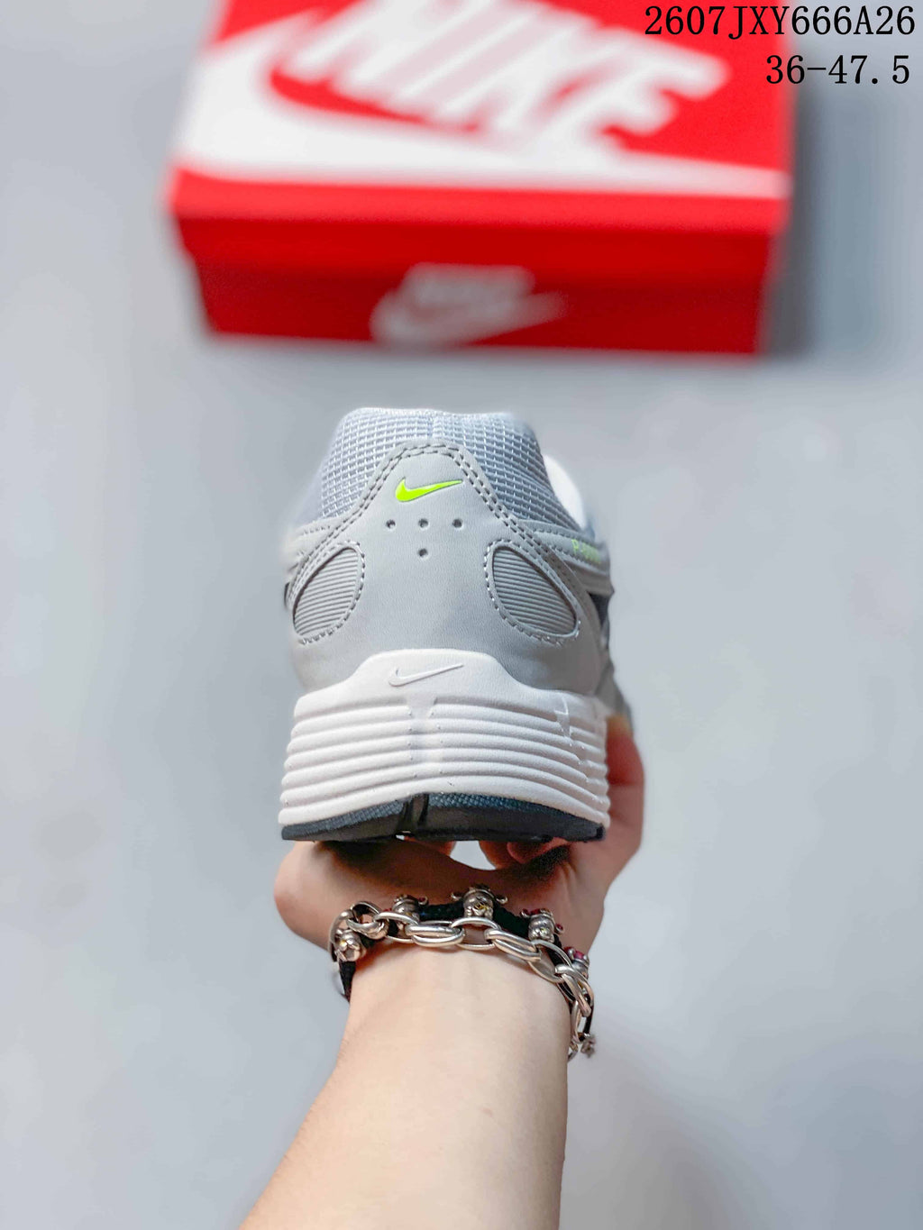 Rear view of the grey sneaker showing the padded collar, heel panels, and layered white midsole.