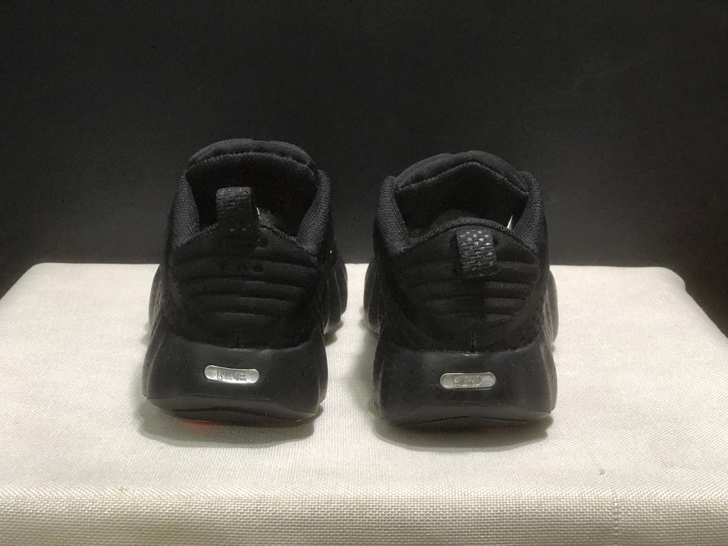 Rear view of the black sneakers showing padded heel collars and pull tabs.