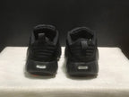 Rear view of the black sneakers showing padded heel collars and pull tabs.