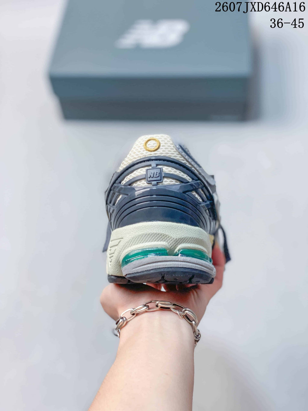 Rear view of a New Balance 1906A sneaker showing the layered heel structure and green cushioning elements.