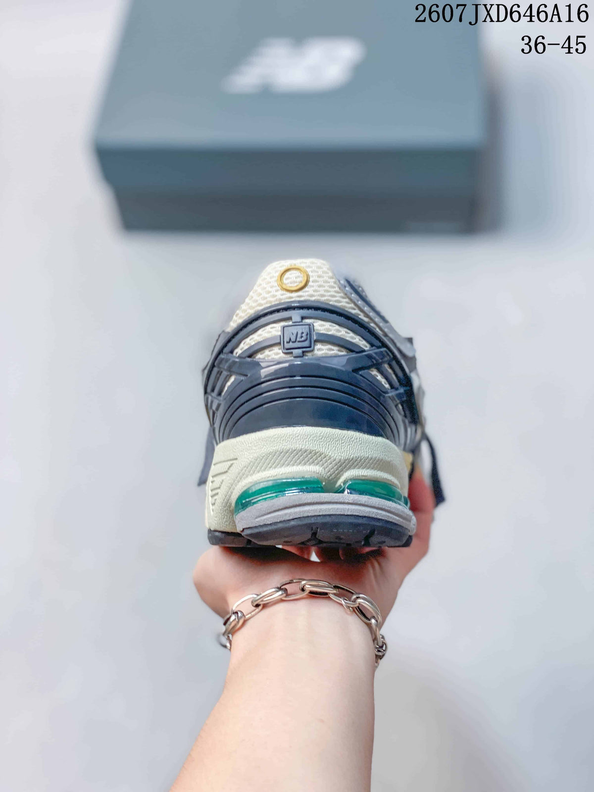 Rear view of a New Balance 1906A sneaker showing the layered heel structure and green cushioning elements.