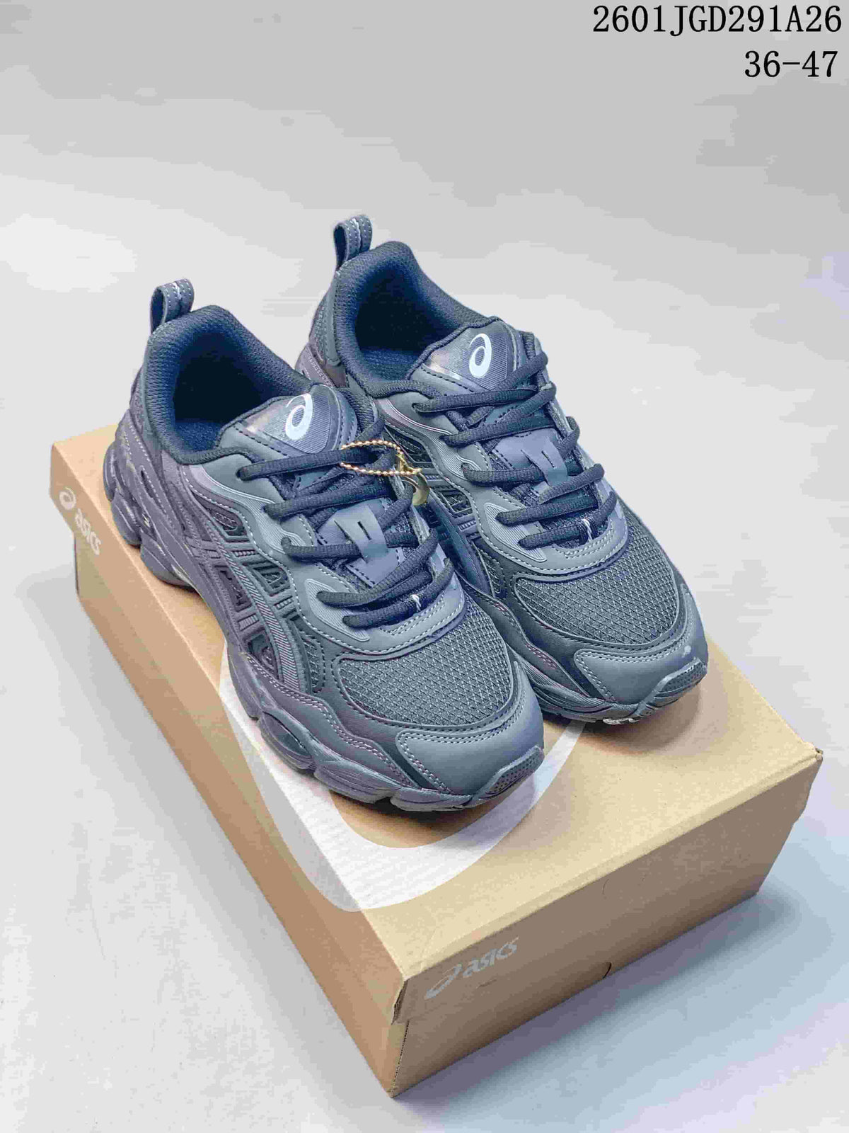 Pair of gray ASICS GEL-NYC sneakers displayed on an ASICS shoebox.