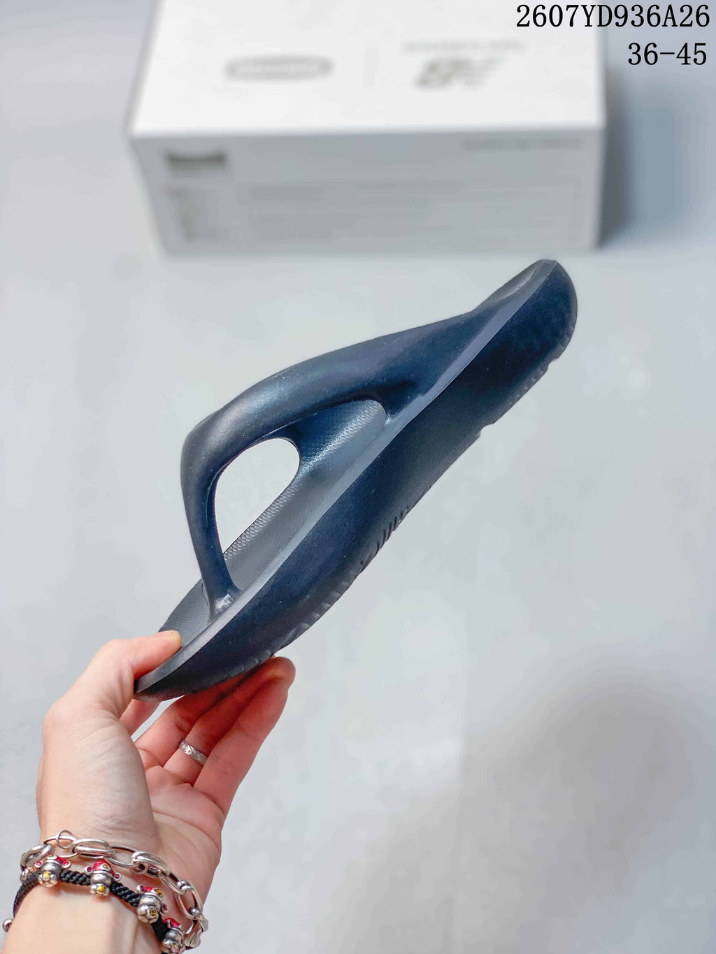 Side view of the black flip-flop sandal showing the raised thong-style upper and sole thickness.