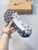 Underside view of the sneaker showing a lugged outsole with dark and light tread sections and circular openings.