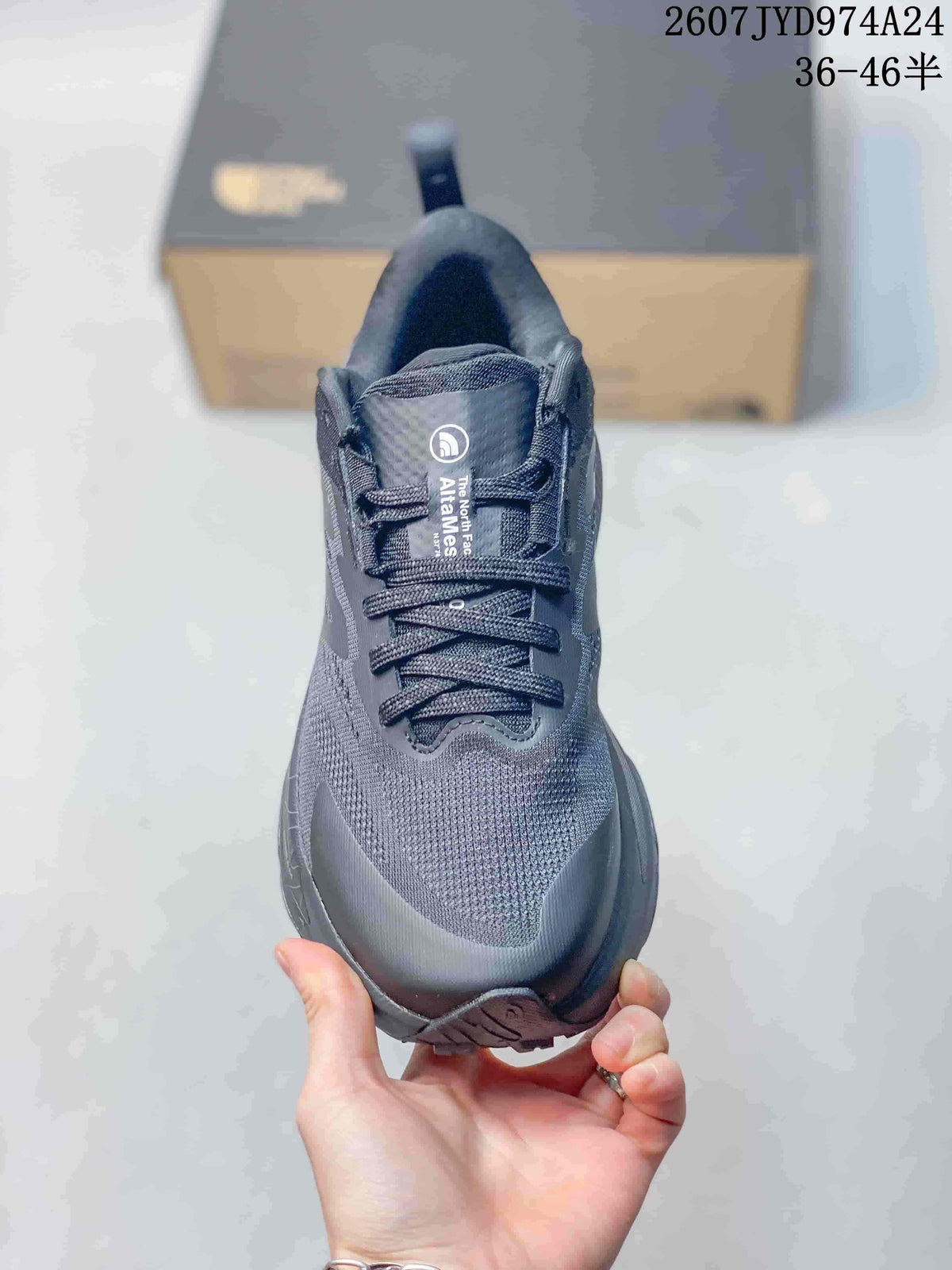 Front view of the dark gray low-top sneaker showing the rounded toe, laces, padded collar, and Altamesa tongue label.