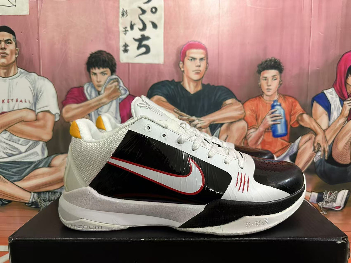 Side view of a Nike basketball shoe with black, white, and red details.