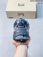 Rear view of a gray sneaker showing the heel and chunky sole