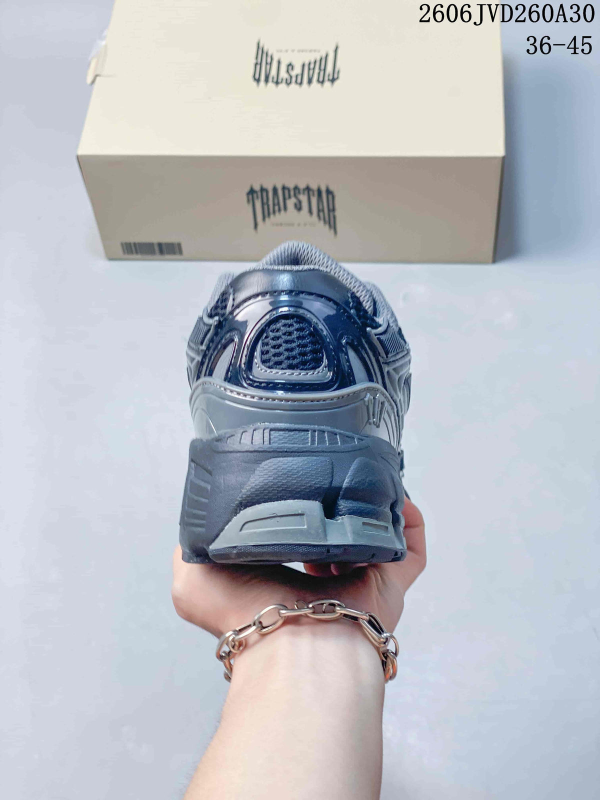 Rear view of a gray sneaker showing the heel and chunky sole