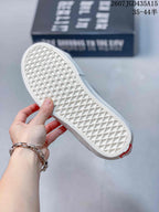 Close-up of the white waffle-pattern outsole on a black Vans sneaker.