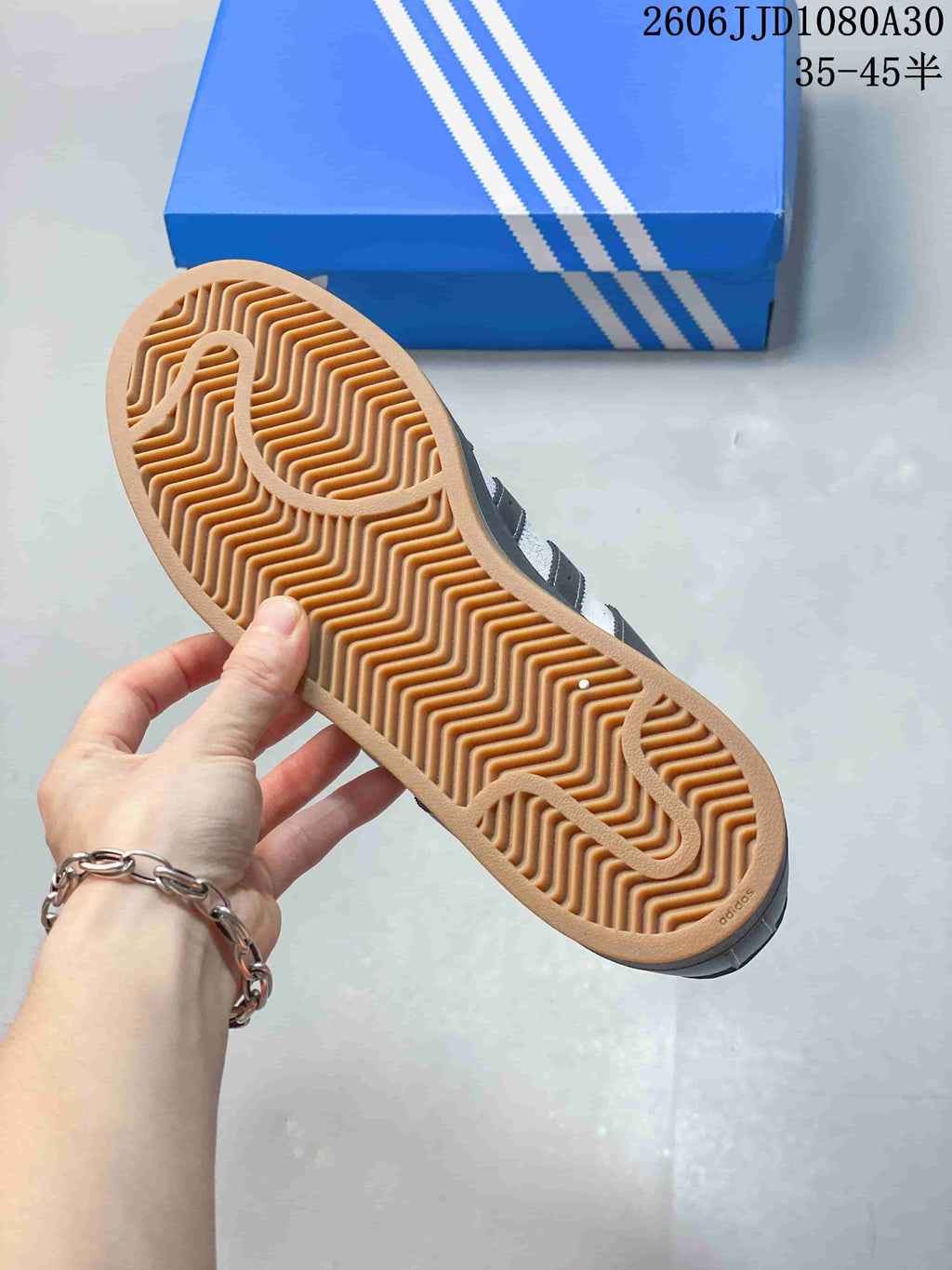 Close-up of the patterned gum-colored outsole on an adidas Superstar sneaker