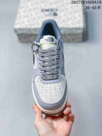 Top view showing the perforated off-white toe box, patterned laces, tongue branding, and lace ornament.