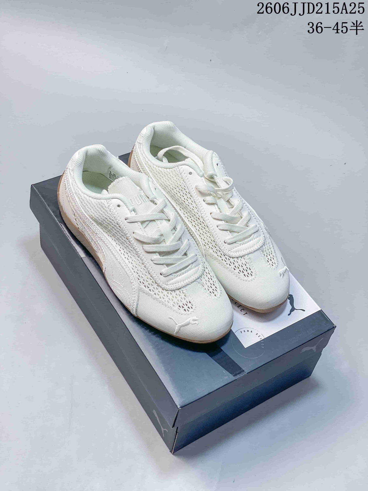 Pair of off-white PUMA Speedcat sneakers displayed on a PUMA shoe box, showing tonal laces, mesh-style panels, and gum-colored soles.