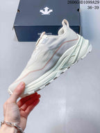 Side view of the off-white DESCENTE sneaker with pale pink accents