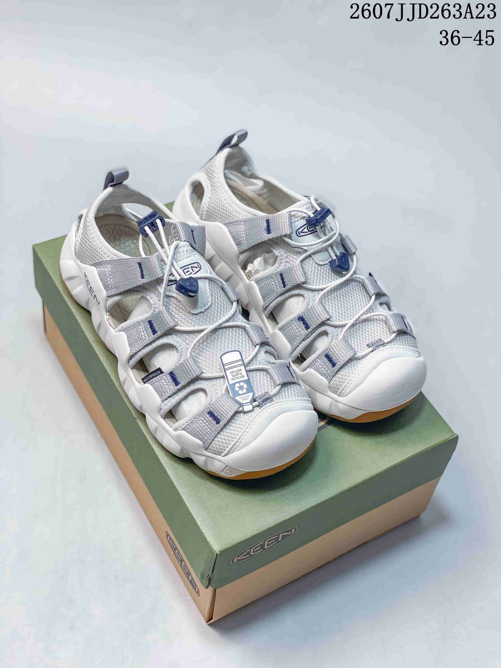 Pair of white and gray KEEN outdoor water-shoe sandals displayed on a shoebox.