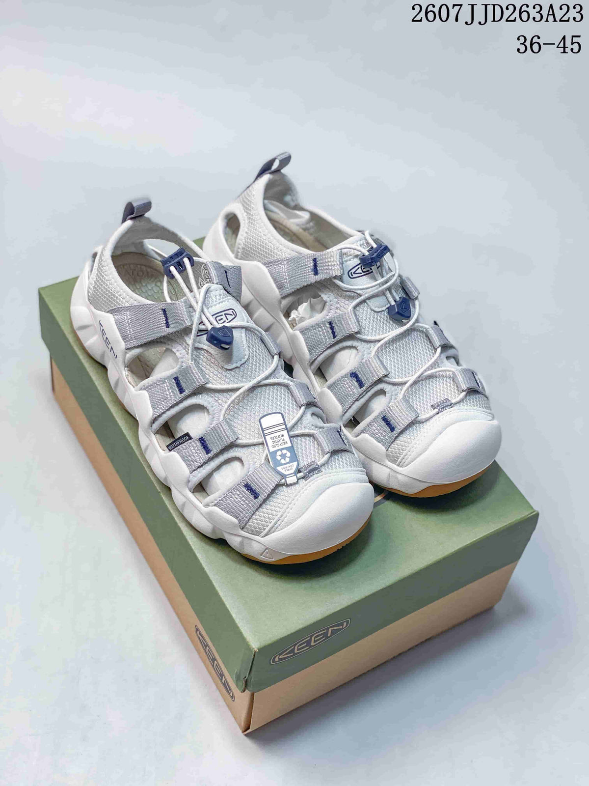Pair of white and gray KEEN outdoor water-shoe sandals displayed on a shoebox.