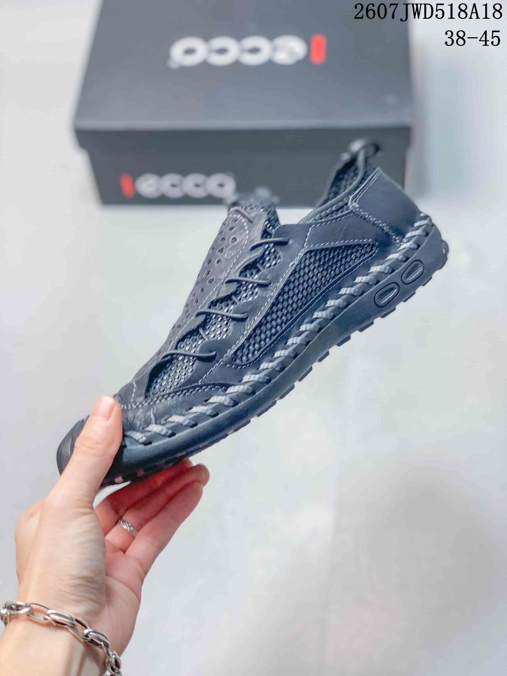 Side view of the black ECCO sneaker showing perforated panels, textile mesh, laces and rugged outsole detailing.